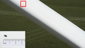 The resolution of the drone's vision system is so fine that a fly is captured resting on one blade