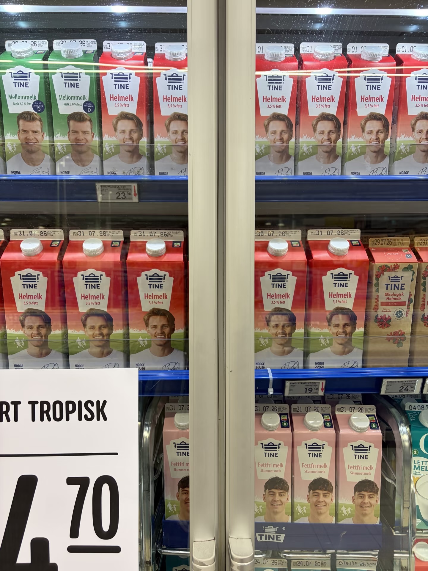 Football-themed dairy packaging, multiple SKUs, and store price labels inside a retail cooler