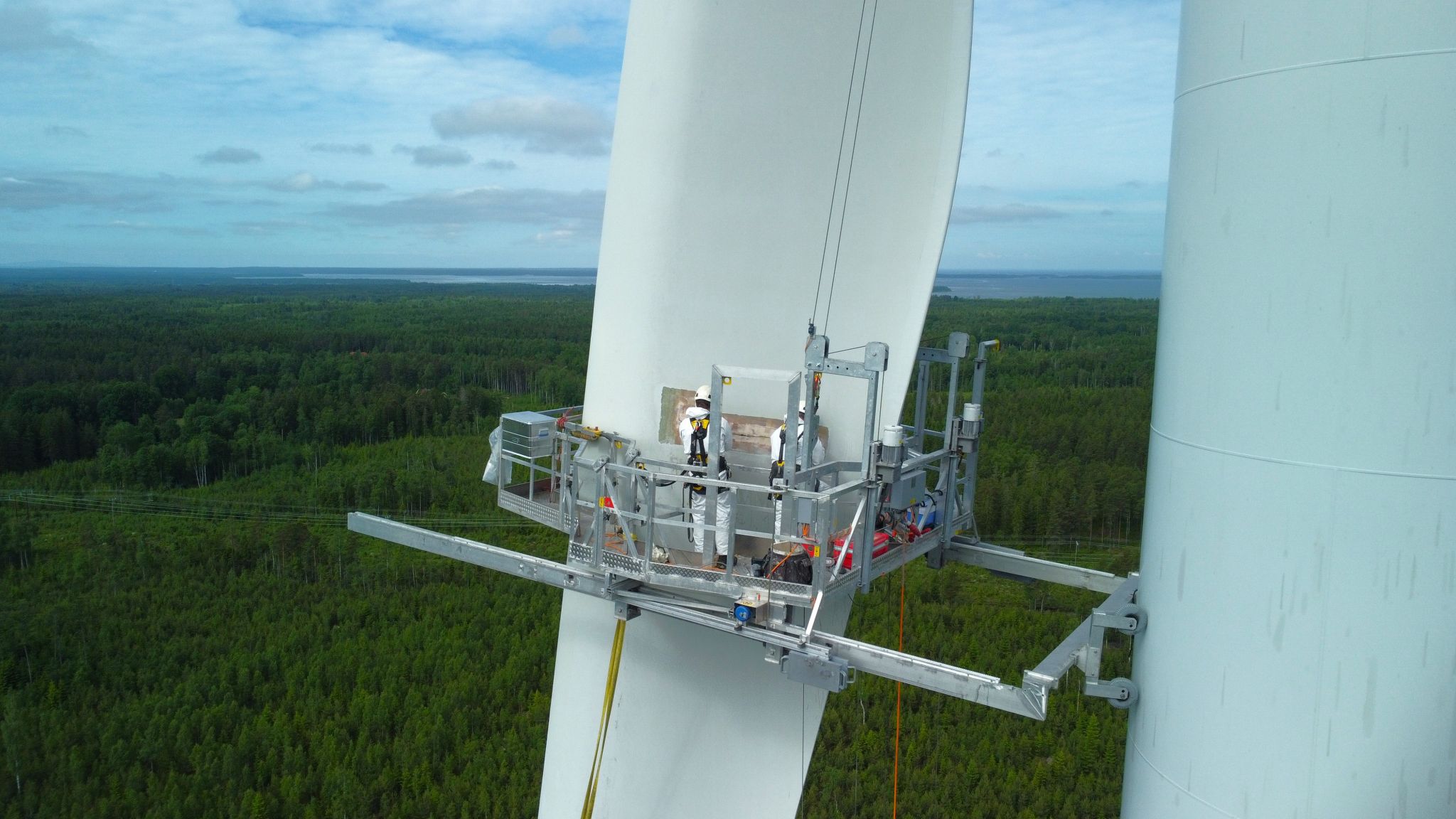 Clobotics field technicians working from a blade access platform
